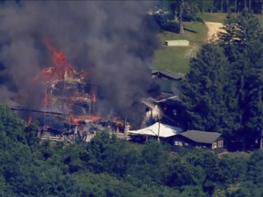 This image taken from video provided by WJLA shows crews battling a fire at Camp Airy for Boys in Thurmont, Md., on Wednesday, June 29, 2022. The building was empty when the fire broke out and no injuries have been reported, Frederick County Division of Fire & Rescue Services spokesperson Sarah Campbell said. Residents and campers were not in the area of the fire, she said.  (WJLA via AP)