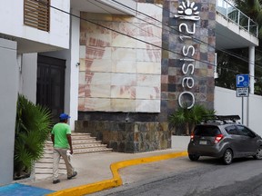 A man walks by Oasis 12 condo where two Canadian citizens, a man and a woman, were killed by unknown assailants, authorities said on Tuesday, in Playa del Carmen, Mexico, June 21, 2022. REUTERS/Stringer
