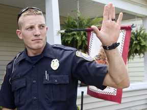 FILE - Grand Rapids Police Officer Christopher Schurr stops to talk with a resident, on Aug. 12, 2015, in Grand Rapids, Mich. Schurr, charged with second-degree murder in the death of Patrick Lyoya, a Black man who was shot in the back of the head in April, has been fired, officials said Wednesday, June 15, 2022.