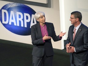 FILE - Arati Prabhakar, left, the director of Defense Advanced Research Projects Agency speaks after introducing then-Defense Secretary Ash Carter to speak Sept. 9, 2015, at the opening of the DARPA conference at the America's Center in St. Louis. President Joe Biden has chosen Arati Prabhakar to be his science adviser.