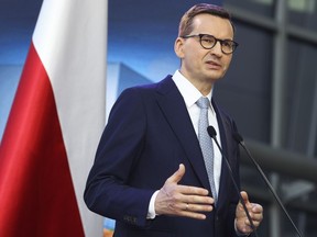 Poland's Prime Minister Mateusz Morawiecki briefs the media during a joint news conference with Polish President Andrzej Duda and European Commission President Ursula von der Leyen at the headquarters of Poland's Power Grid in Konstancin-Jeziorna, Poland, Thursday, June 2, 2022. The independence of Poland's courts is at the heart of a dispute with the European Union, which has withheld billions of euros in pandemic recovery funds. European Commission President Ursula von der Leyen meets Poland's leaders discuss the matter.