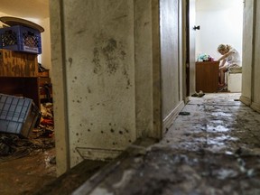 Harley Holmes, 8, cleans out her room as her family is forced to leave their home left damaged by severe flooding in Fromberg, Mont., Friday, June 17, 2022.