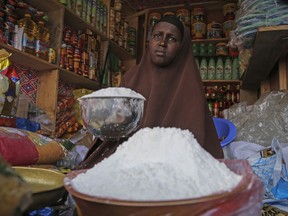 FILE - A shopkeeper sells wheat flour in the Hamar-Weyne market in the capital Mogadishu, Somalia on May 26, 2022. "Africa is actually taken hostage" in Russia's invasion of Ukraine amid catastrophically rising food prices, Ukrainian President Volodymyr Zelenskyy told the African Union during a closed-door address on Monday, June 20, 2022.
