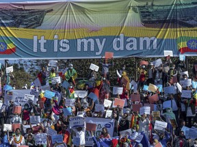 FILE - Ethiopians protest against international pressure on the government over the conflict in Tigray, below a banner referring to The Grand Ethiopian Renaissance Dam, at a demonstration organised by the city mayor's office held at a stadium in the capital Addis Ababa, Ethiopia on May 30, 2021. A senior Ethiopian official said Friday, June 10, 2022 his country is interested in resuming talks with Egypt and Sudan on the huge and controversial Blue Nile dam that will be Africa's largest hydroelectric power plant.