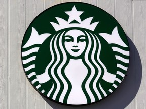 The mermaid logo on a sign outside the Starbucks coffee shop, Monday, March 14, 2022, in Londonderry, N.H. Rossann Williams, Starbucks' North America president who's been a prominent figure in the company's push against worker unionization, is leaving the company after 17 years.