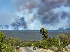 The Calf Canyon/Hermit Peak Fire burns in the mountains near Pecos, N.M., on Thursday May 25, 2022.