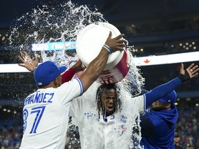 Toronto Blue Jays first baseman Vladimir Guerrero Jr. (27) reacts after being doused with water by Teoscar Hernandez (37) after hitting the game winning RBI single to defeat the Baltimore Orioles during tenth inning American League, MLB baseball action in Toronto on June 15, 2022. Guerrero Jr. was named AL player of the week on Tuesday after hitting .407 with three home runs and seven RBIs over seven games.