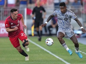 CF Montréal forward Romell Quioto (30) controls the ball near the touch-line as Toronto FC defender Shane O'Neill (27) gives chase during first half Voyageurs Cup semifinal soccer action in Toronto on Wednesday, June 22, 2022.