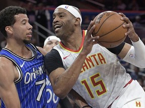 FILE - Atlanta Hawks forward Vince Carter (15) drives to the basket against Orlando Magic guard Michael Carter-Williams (7) during the first half of an NBA basketball game in Orlando, Fla., Friday, April 5, 2019. Police say nearly $100,000 in cash was taken in a weekend burglary at the Atlanta home of former NBA player Vince Carter. Police said in an incident report released Wednesday, June 22, 2022 that two guns and more than $16,000 was recovered outside the home after Sunday's burglary.