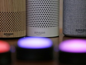 FILE - Amazon Echo and Echo Plus devices, behind, sit near illuminated Echo Button devices during an event by the company in Seattle on Sept. 27, 2017. Amazon's Alexa might soon replicate the voice of family members - even if they're dead. The capability, unveiled at Amazon's Re:Mars conference in Las Vegas Wednesday, June 22, 2022, is in development and would allow the virtual assistant to mimic the voice of a specific person based on a less than a minute of provided recording.