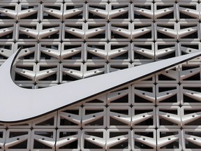 FILE - The Nike logo hangs at a store in Miami Beach, Fla. on Aug. 8, 2017. Nike says it will exit the Russian marketplace, the latest company with plans to leave the country amid the ongoing invasion of Ukraine. The footwear and clothing company said in a statement on Thursday, June 23, 2022, that its "priority is to ensure we are fully supporting our employees while we responsibly scale down our operations over the coming months."