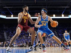 FILE - UCLA guard Jaime Jaquez Jr., right, tries to get by Southern California forward Isaiah Mobley during the second half of an NCAA college basketball game on March 5, 2022, in Los Angeles. UCLA and Southern California are planning to leave the Pac-12 for the Big Ten Conference in a seismic change that could lead to another major realignment of college sports. A person who spoke to The Associated Press on Thursday, June 30, 2022, on condition of anonymity because the schools' talks with the Big Ten have not been made public said the schools have taken steps to request an invitation to join the conference.