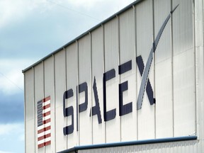 FILE - a SpaceX logo is displayed on a building on May 26, 2020, at the Kennedy Space Center in Cape Canaveral, Fla. SpaceX, the rocket ship company run by Tesla CEO Elon Musk, has fired several employees involved in an open letter that blasted the colorful billionaire for his behavior, according to media reports Friday, June 17, 2022.