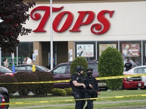FILE - Police secure an area around a supermarket where several people were killed in a shooting, Saturday, May 14, 2022, in Buffalo, N.Y. New York's new law barring sales of bullet-resistant vests to most civilians doesn't cover the type of armor worn by the gunman who killed 10 people at the Buffalo supermarket, a gap that could limit its effectiveness in deterring future military-style assaults.