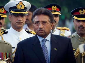 FILE - Outgoing President Pervez Musharraf is surrounded by top military officers as he leaves the Presidential House in Islamabad, Pakistan on Aug. 18, 2008, file photo. Musharraf, Pakistan's former military ruler, is critically ill and has been hospitalized in Dubai since last month, his family said Friday, June 10, 2022.