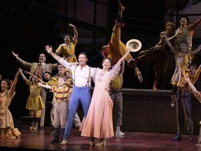 This image released by O & M Co./DKC shows Hugh Jackman, foreground left, and Sutton Foster with the cast during a production of "The Music Man" in New York.