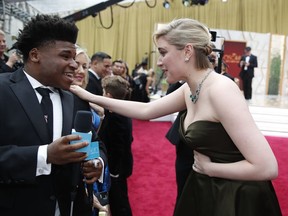 FILE - Greta Gerwig, right, talks to Jerry Harris on the red carpet at the Oscars at the Dolby Theatre in Los Angeles, Feb. 9, 2020. Former "Cheer" star Jerry Harris has pleaded guilty to felony child pornography and child sex charges in federal court. The 22-year-old Harris entered his plea on Thursday, Feb. 10, 2022 to receiving child pornography and traveling with the intent to engage in illicit sexual conduct.