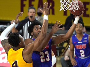 FILE - Houston Baptist guard Darius Lee (23) during the first half of an NCAA college basketball game against Arizona State, Nov. 29, 2020, in Tempe, Ariz. Lee was killed and eight other people were wounded Monday, June 20, 2022 in an early-morning shooting at a gathering in Harlem, New York City police said. Officers responded around 12:40 a.m. to reports of a shooting on a footpath along FDR Drive and found several people wounded. Other victims went to hospitals on their own.