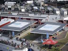 Solar arrays help power the Florida Power & Light Solar Circuit and provide shade in the infield during a NASCAR Xfinity Series auto race at Daytona International Speedway, Feb. 16, 2019, in Daytona Beach, Fla. Florida's largest electric provider has announced plans to eliminate all of its carbon emissions by 2045 by increasing its reliance on solar energy, including using it to turn water into hydrogen to fuel its power plants. Florida Power & Light says the multibillion dollar plan will not result in any price increases beyond what would be anticipated normally for its nearly 6 million customers.