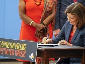 FILE -- New York Gov. Kathy Hochul signs a package of bills to strengthen gun laws, June 6, 2022, in New York. The Supreme Court, Thursday, June 23, 2022, struck down a restrictive New York gun law in a major ruling for gun rights.