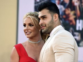 FILE - Britney Spears and Sam Asghari arrive at the Los Angeles premiere of "Once Upon a Time in Hollywood," at the TCL Chinese Theatre, Monday, July 22, 2019. Spears and her partner Asghari announced in a joint post on Instagram, Saturday, May 14, 2022, that they had lost their baby during pregnancy. The announcement came a little over a month after the couple revealed they were expecting a child.