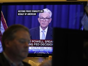 Federal Reserve Chairman Jerome Powell news conference is displayed on televisions while traders work on the floor at the New York Stock Exchange in New York, Wednesday, June 15, 2022. The Federal Reserve on Wednesday intensified its drive to tame high inflation by raising its key interest rate by three-quarters of a point -- its largest hike in nearly three decades -- and signaling more large rate increases to come that would raise the risk of another recession.