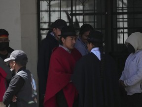 Indigenous leader Leonidas Iza, center, waits with members of his delegation at the Basilica del Voto Nacional where dialogue with the government broke down in downtown Quito, Ecuador, Tuesday, June 28, 2022. Ecuadorian President Guillermo Lasso announced a cut in gasoline prices Sunday that fell short of the reduction demanded by Indigenous leaders to end a strike that has paralyzed parts of the country for two weeks.