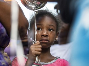 A girl cries during a balloon release vigil, Friday, June 10, 2022, for Alexis Quinn, who was killed in the Philadelphia South Street mass shooting last weekend.