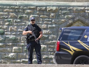 A member of the Parliamentary Protective Service (PPS) responds to an incident on Parliament Hill in Ottawa on Saturday, June 11, 2022.