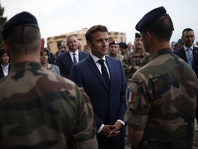 French President Emmanuel Macron greets French soldiers at the Mihail Kogalniceanu Air Base, near the city of Constanta, Romania, Tuesday, June 14, 2022. French President Emmanuel Macron travels to Romania where he is set to hold bilateral talks with officials and meet with French troops who are part of NATO's response to Russia's invasion of Ukraine. France has around 500 soldiers deployed in Romania and has been a key player in NATO's bolstering of forces on the alliance's eastern flank following Russia's invasion on Feb. 24.
