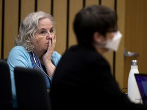 Romance writer Nancy Crampton Brophy, left, accused of killing her husband, Dan Brophy, in June 2018, watches proceedings in court in Portland, Ore., on April 4, 2022.