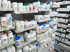 Prescription drugs are seen on shelves at a pharmacy in Montreal, Thursday, March 11, 2021.&ampnbsp;The Parliamentary Budget Officer says changes to the way Canada sets drug prices will lower drug spending by about seven per cent&ampnbsp; over the long term.