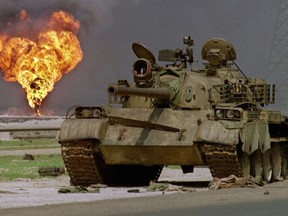 An abandoned Iraqi Soviet-made T-62 tank sits in Kuwaiti desert in April 1991.