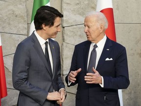 Prime Minister Justin Trudeau and U.S. President Joe Biden talk as they take part in a G7 family photo at NATO headquarters in Brussels, Belgium on Thursday, March 24, 2022. THE CANADIAN PRESS/Sean Kilpatrick