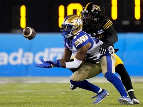 Winnipeg Blue Bombers wide receiver Rasheed Bailey (88) makes a catch under pressure from Hamilton Tiger-Cats defensive back Tunde Adeleke (2) during second half football action in the 108th CFL Grey Cup in Hamilton, Ont., on Dec. 12, 2021.