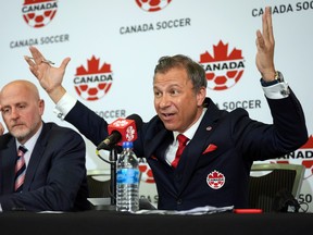 Canada Soccer president Nick Bontis, right, speaks during a news conference, in Vancouver, on June 5, 2022. After refusing to train on Friday and Saturday, Canada's men's soccer team said it refused to play its World Cup warmup match against Panama Sunday because of a labour dispute with Soccer Canada.