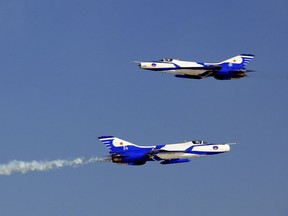 FILE - Two J-7 fighters perform in an aerobatic show to celebrate the 60th anniversary of the People's Liberation Army Air Force in Beijing on Nov. 11, 2009. State broadcaster CCTV's military channel reported that a Chinese air force fighter jet went down near an airport in Xiangyang in Hubei province on Thursday morning. (AP Photo, File)