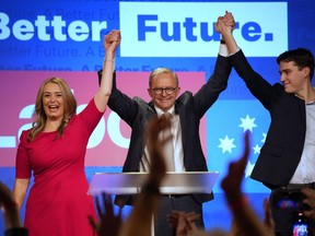 FILE - Labor Party leader Anthony Albanese, center, celebrates with his son Nathan, right, and his partner Jodie Haydon at a Labor Party event in Sydney, Australia, on May 22, 2022, after then Prime Minister Scott Morrison conceding defeat to Albanese in a federal election. Authorities are to declare the final seat on Wednesday, June 22, in a greener, more fragmented Australian Parliament following May 21 elections.