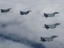 Japanese and U.S. joint fighter jets fly in formation over the Sea of Japan, Tuesday, June 7, 2022.