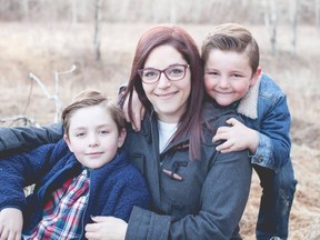 Jennifer Henson and her sons Kayden, left, and Chase are seen in Calgary in this undated handout image provided June 22, 2022. A steep hike in gas prices and cost of living has been an adjustment for many Canadians, particularly Henson, a mail carrier who says her out-of-pocket cost of delivering packages along her rural route has doubled.