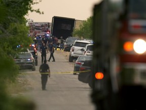 Body bags lie at the scene where a tractor trailer with multiple dead bodies was discovered on June 27, 2022 in San Antonio, Texas.