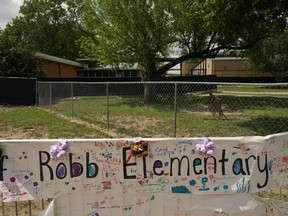 A sign with encouraging messages hangs at a memorial at Robb Elementary School created to honor the victims killed in the recent school shooting, Thursday, June 9, 2022, in Uvalde, Texas. The Texas elementary school where a gunman killed 19 children and two teachers has long been a part of the fabric of the small city of Uvalde, a school attended by generations of families, and where the spark came that led to Hispanic parents and students to band together to fight discrimination over a half-century ago.