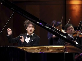 In this photo provided by The Cliburn, Yunchan Lim, of South Korea, performs a concerto with the Fort Worth Symphony Orchestra conducted by Chairman of the Jury Marin Alsop in the final round of the 16th Van Cliburn International Piano Competition at Bass Performance Hall in Fort Worth, Texas, on June 12, 2022. The 18-year-old has won the competition, one of the top showcases for the world's best pianists.