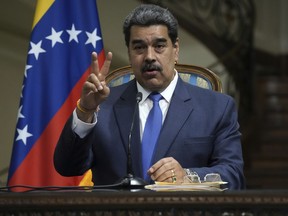 Venezuela's President Nicolas Maduro gestures as he speaks in a joint news briefing with his Iranian counterpart Ebrahim Raisi at the Saadabad Palace in Tehran, Iran, Saturday, June 11, 2022.