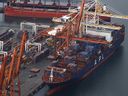 VANCOUVER, BRITISH COLUMBIA - NOVEMBER 20: In an aerial view, a container ship sits docked at the Port of Vancouver on November 20, 2021 in Vancouver, British Columbia. The Canadian province of British Columbia declared a state of emergency on Wednesday following record rainfall earlier this week that has resulted in widespread flooding of farms, landslides and road washouts that  have halted railway access to the Port of Vancouver, Canada’s largest maritime hub. The rains have also cut off major transport routes between British Columbia's lower mainland and the province’s interior. Shortages of consumer goods and possible gasoline shortages could impact the region. (Photo by Justin Sullivan/Getty Images)