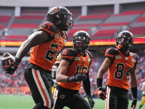 B.C. Lions' James Butler, from left to right, Bryan Burnham and Keon Hatcher celebrate Butler's first touchdown against the Edmonton Elks during the first half of CFL football game in Vancouver, on Saturday, June 11, 2022. The Lions have signed wide receiver Keon Hatcher to a contract extension through the 2023 season.