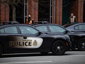 Police cars are seen parked outside Vancouver Police Department headquarters in Vancouver, on Saturday, Jan. 9, 2021. British Columbia's police complaint commissioner has set off an investigation into the conduct of 19 officers from eight separate police departments.THE CANADIAN PRESS/Darryl Dyck