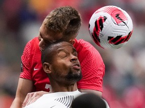 Curacao's Rangelo Janga, front, and Canada's Alistair Johnston vie for the ball during the first half of a CONCACAF Nations League soccer match, in Vancouver, on Thursday, June 9, 2022.