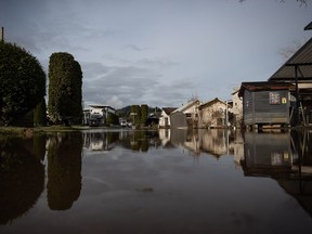 Floodwaters cover a road after water began to recede at Everglades Resort on Hatzic Lake near Mission, B.C., on Sunday, December 5, 2021.&ampnbsp;Evacuation orders have been issued for three small communities in northwestern British Columbia as the flood risk rises across the region.