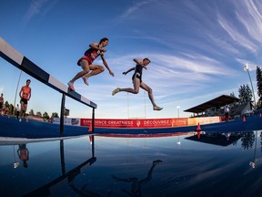John Gay, right, of Kelowna, B.C., races to a first place finish ahead of Jean-Simon Desgagnes, of Laval, Que., who finished third, during the men's 3,000 metre steeplechase event at the Canadian Track and Field Championships in Langley, B.C., on Friday, June 24, 2022.